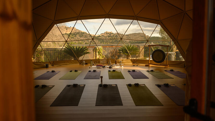 The space before the experience — Limitless Retreat Geodesic retreat venue prepared with yoga mats, blankets and a large gong